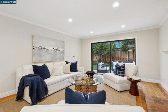 living room with hardwood / wood-style flooring and crown molding