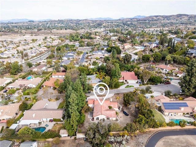 birds eye view of property with a mountain view