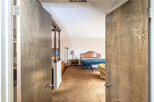 bedroom featuring carpet and a textured ceiling