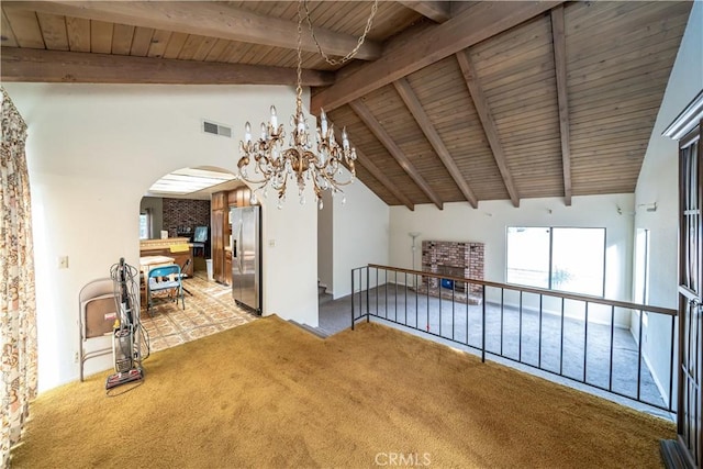 unfurnished room featuring lofted ceiling with beams, carpet flooring, a notable chandelier, and wood ceiling