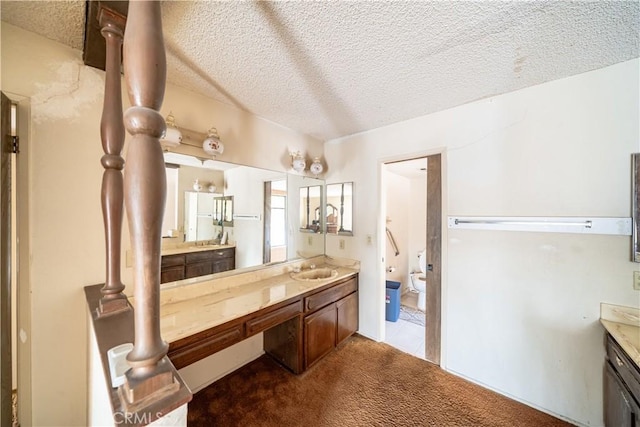 bathroom featuring vanity and a textured ceiling