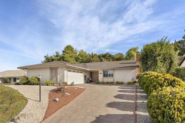 ranch-style home featuring a garage