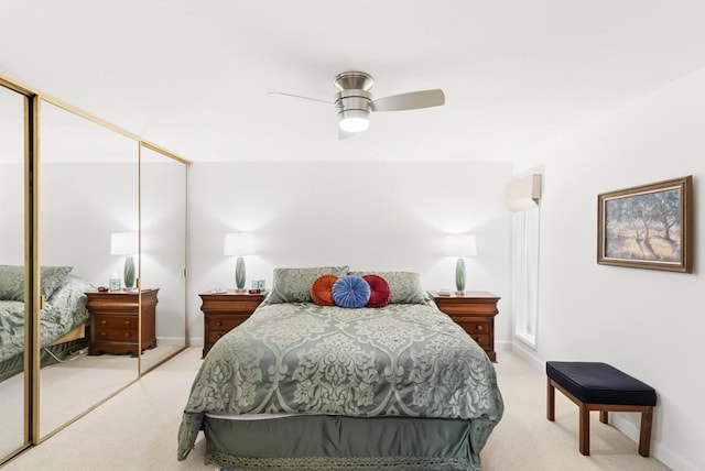 bedroom featuring ceiling fan, a closet, and light carpet