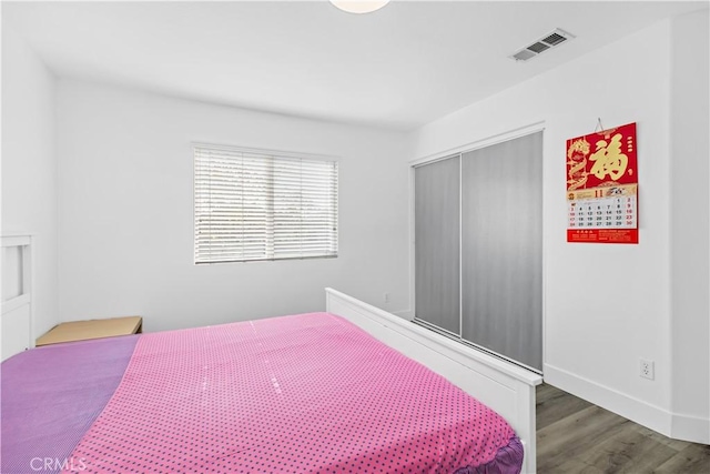 bedroom with hardwood / wood-style flooring and a closet