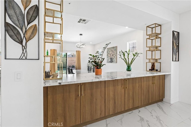 kitchen with hanging light fixtures and kitchen peninsula