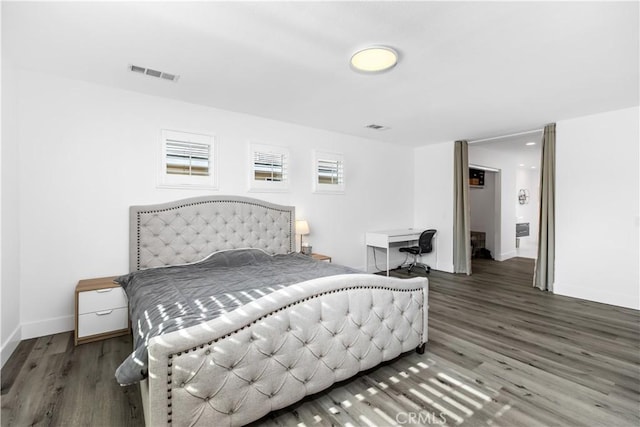 bedroom with dark hardwood / wood-style floors