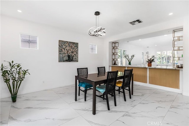 dining area with an inviting chandelier and a wealth of natural light