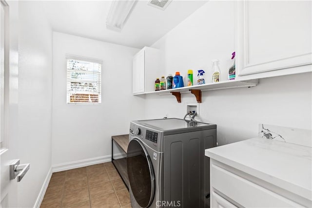 washroom with cabinets, washer / clothes dryer, and light tile patterned floors