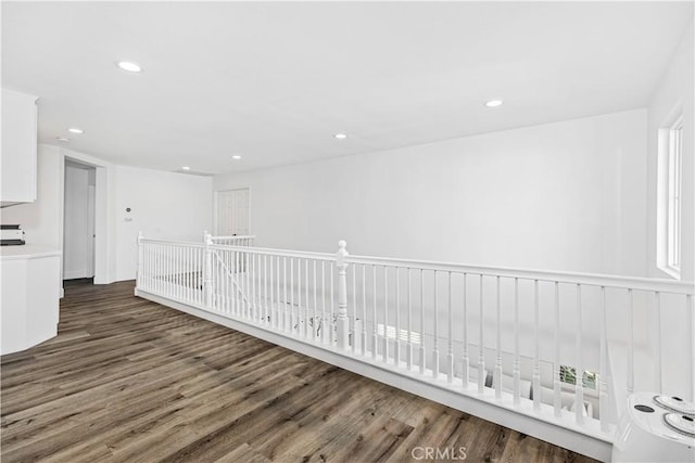 hallway with dark hardwood / wood-style flooring