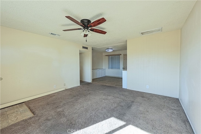 empty room featuring ceiling fan, a textured ceiling, and carpet flooring