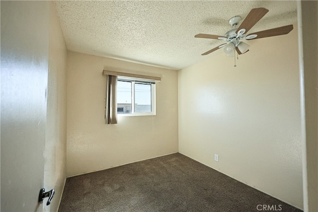 carpeted empty room with ceiling fan and a textured ceiling