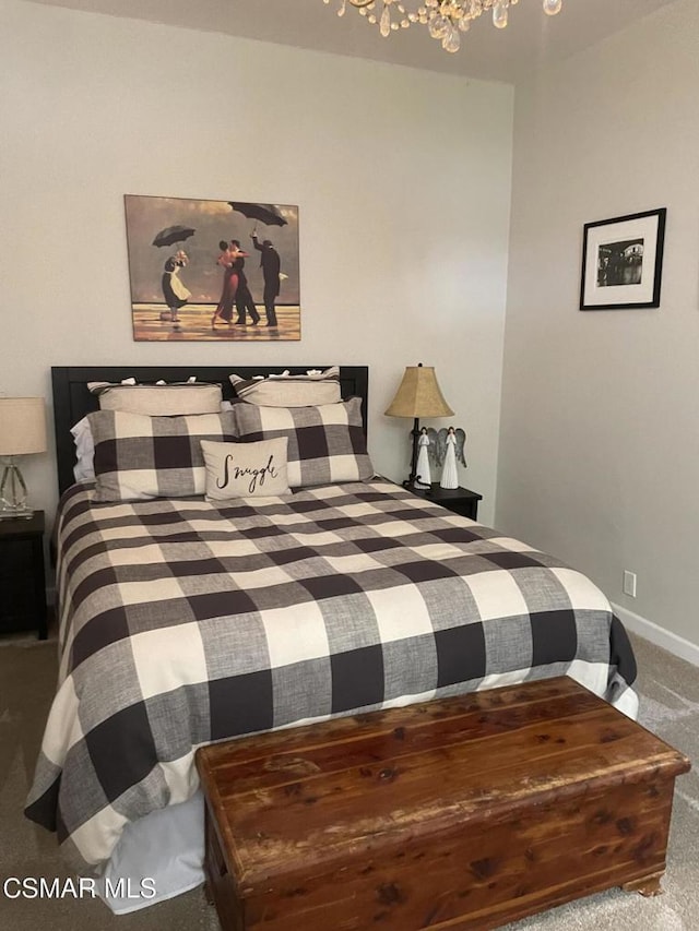 carpeted bedroom with a notable chandelier