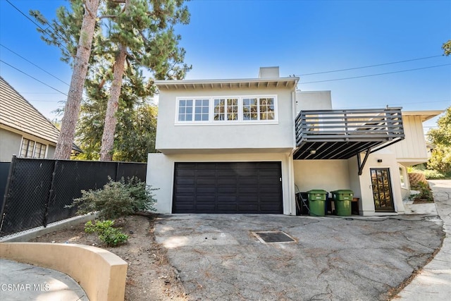 view of front of house with a balcony and a garage