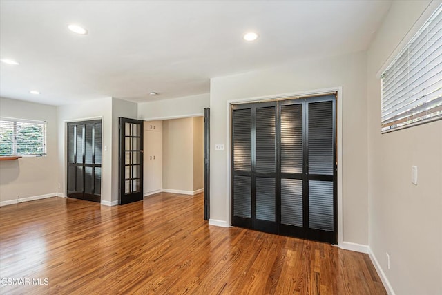 spare room with hardwood / wood-style floors