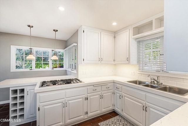 kitchen with white cabinetry, sink, pendant lighting, and gas cooktop