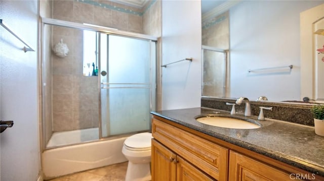 full bathroom with vanity, tile patterned floors, toilet, and combined bath / shower with glass door