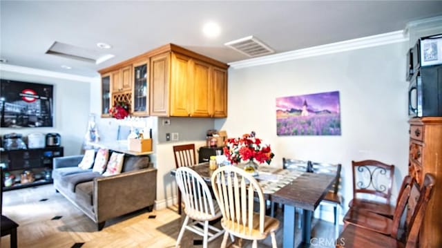 dining area featuring ornamental molding and light parquet flooring