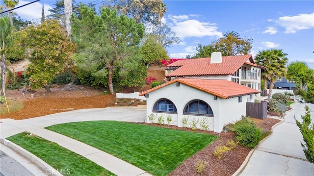 mediterranean / spanish-style house with a front yard