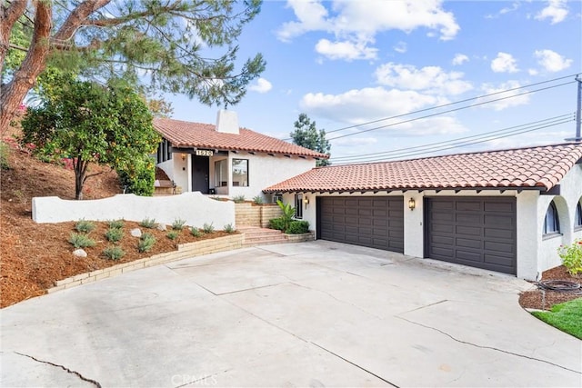 mediterranean / spanish-style home with a garage