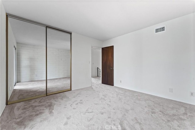 unfurnished bedroom featuring carpet and a closet