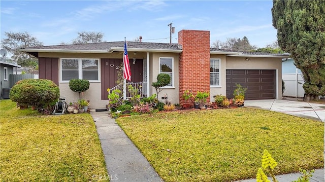 view of front of house with a garage and a front yard