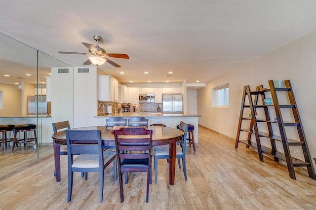 dining area featuring ceiling fan and light hardwood / wood-style flooring