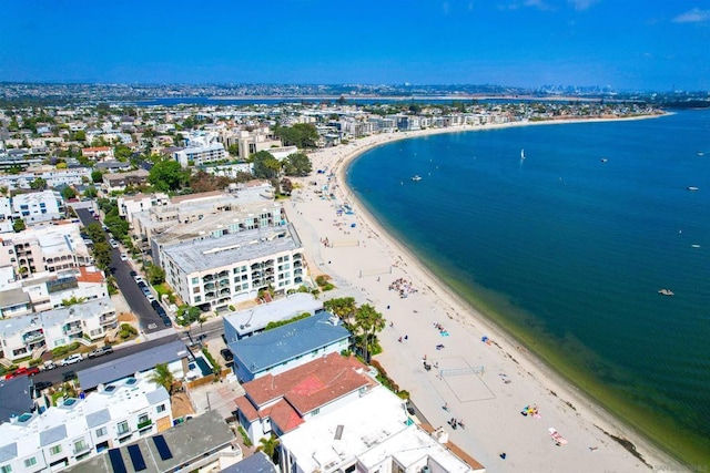 birds eye view of property featuring a beach view and a water view