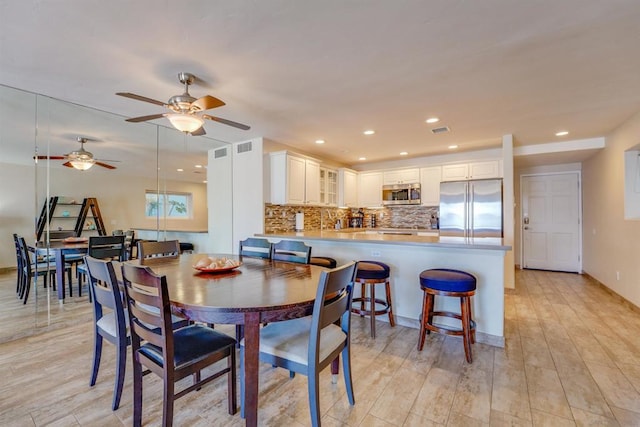 dining space with light hardwood / wood-style floors