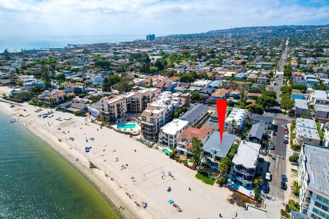 bird's eye view featuring a water view and a beach view