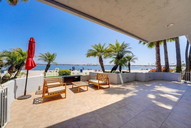 view of patio / terrace with an outdoor living space and a water view