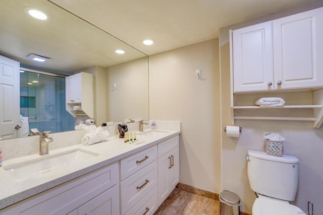 bathroom with vanity, toilet, an enclosed shower, and wood-type flooring