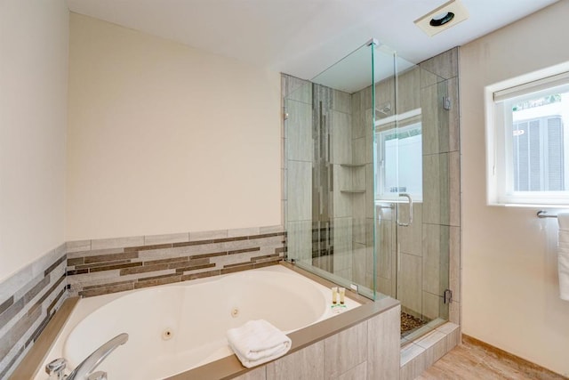 bathroom with wood-type flooring and plus walk in shower