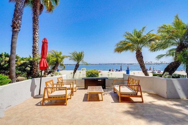 view of patio with a water view and outdoor lounge area