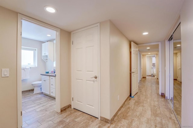 corridor with light hardwood / wood-style floors