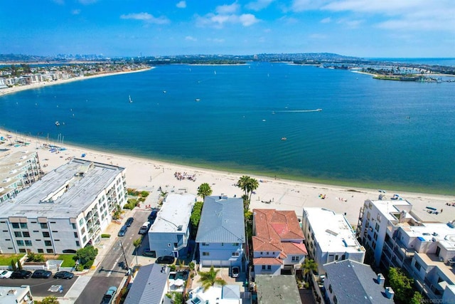 birds eye view of property featuring a water view and a beach view