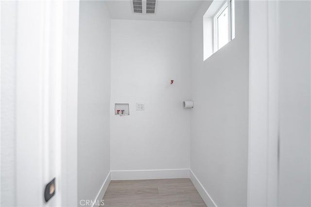 laundry room featuring hookup for a washing machine and light hardwood / wood-style flooring