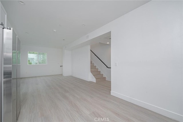 unfurnished room with light hardwood / wood-style flooring