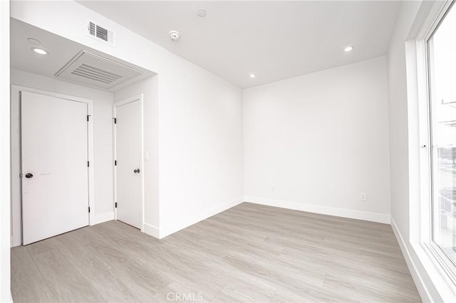 spare room with light hardwood / wood-style floors