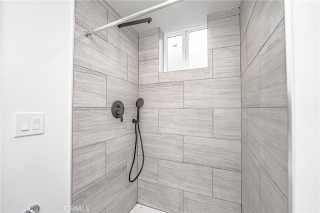 bathroom with tiled shower