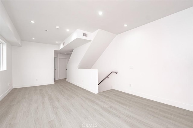 additional living space featuring light hardwood / wood-style flooring