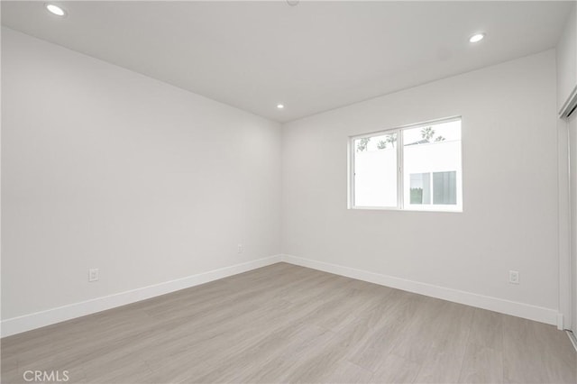 spare room with light hardwood / wood-style flooring