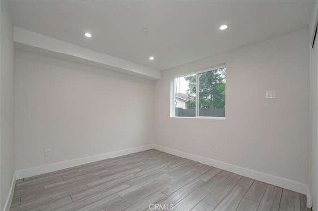 spare room featuring light wood-type flooring