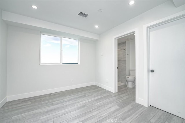 spare room featuring light hardwood / wood-style floors