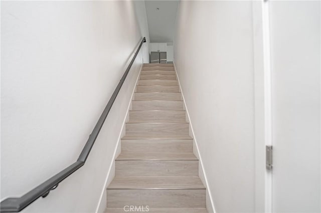 stairway featuring wood-type flooring