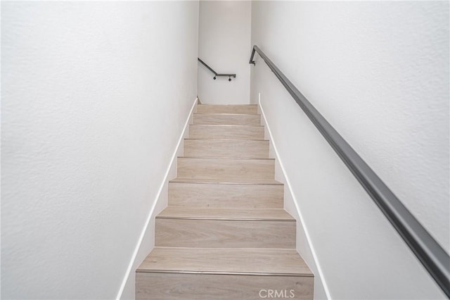 staircase with wood-type flooring