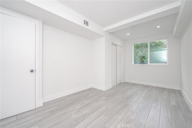 spare room with light hardwood / wood-style floors