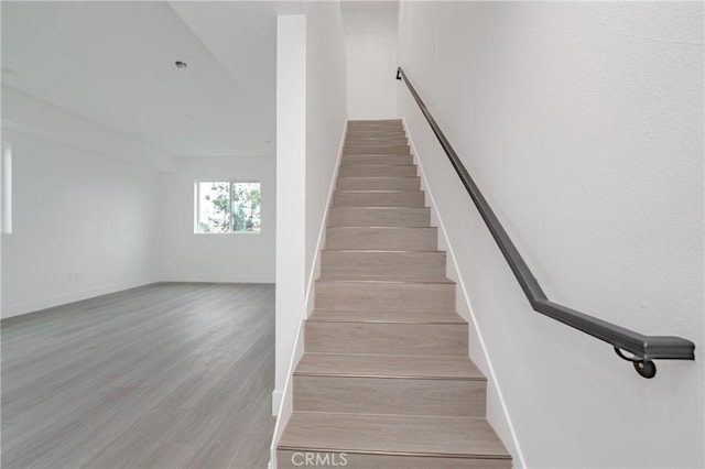 stairs with hardwood / wood-style floors