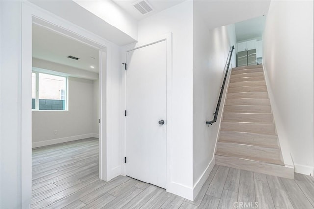 staircase with hardwood / wood-style flooring