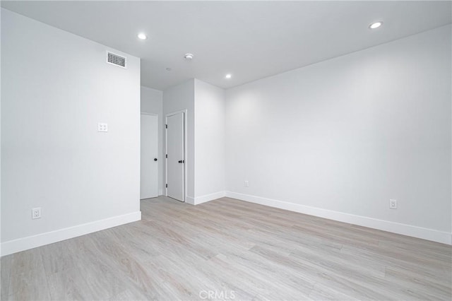 spare room featuring light hardwood / wood-style flooring