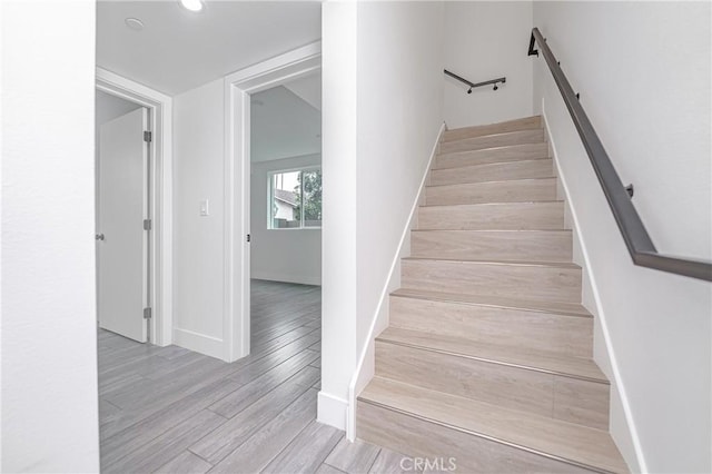 stairs with hardwood / wood-style flooring